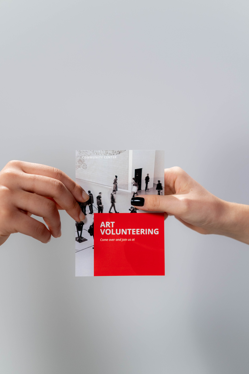 Hands holding Red Brochure